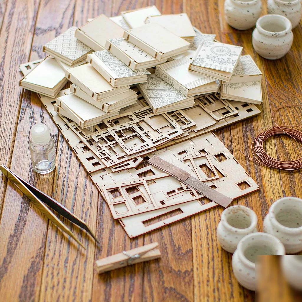 Laser-cut plywood sheets, tweezers and wood glue